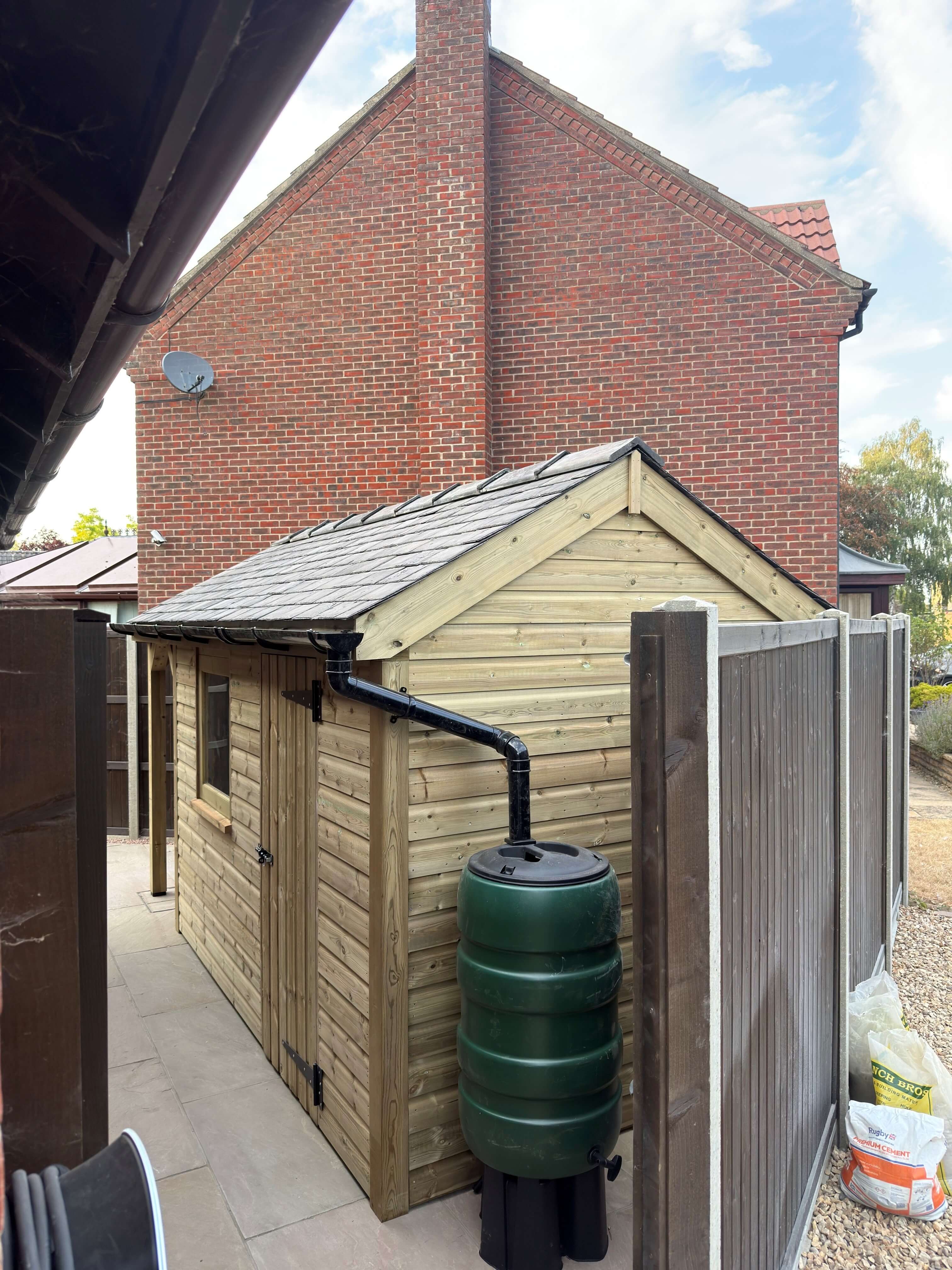 Timber garden shed gable with reclaimed Welsh slate pitched roof
